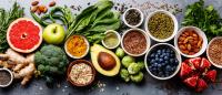 table full of fruits, vegetables, nuts and grains